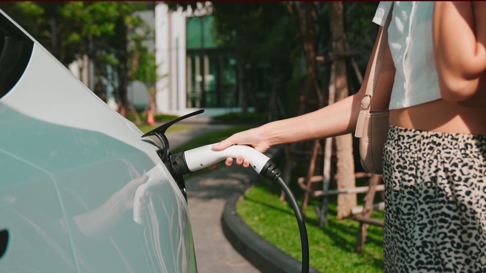 Wall-mounted home EV charger fitted to a UK driveway with an electric car charging